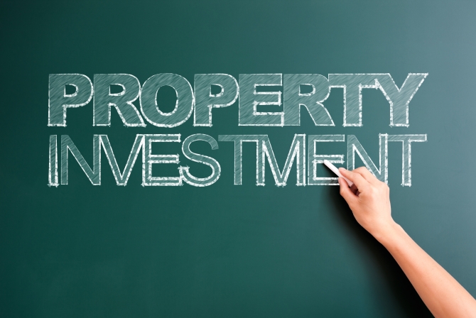 writing property investment on blackboard